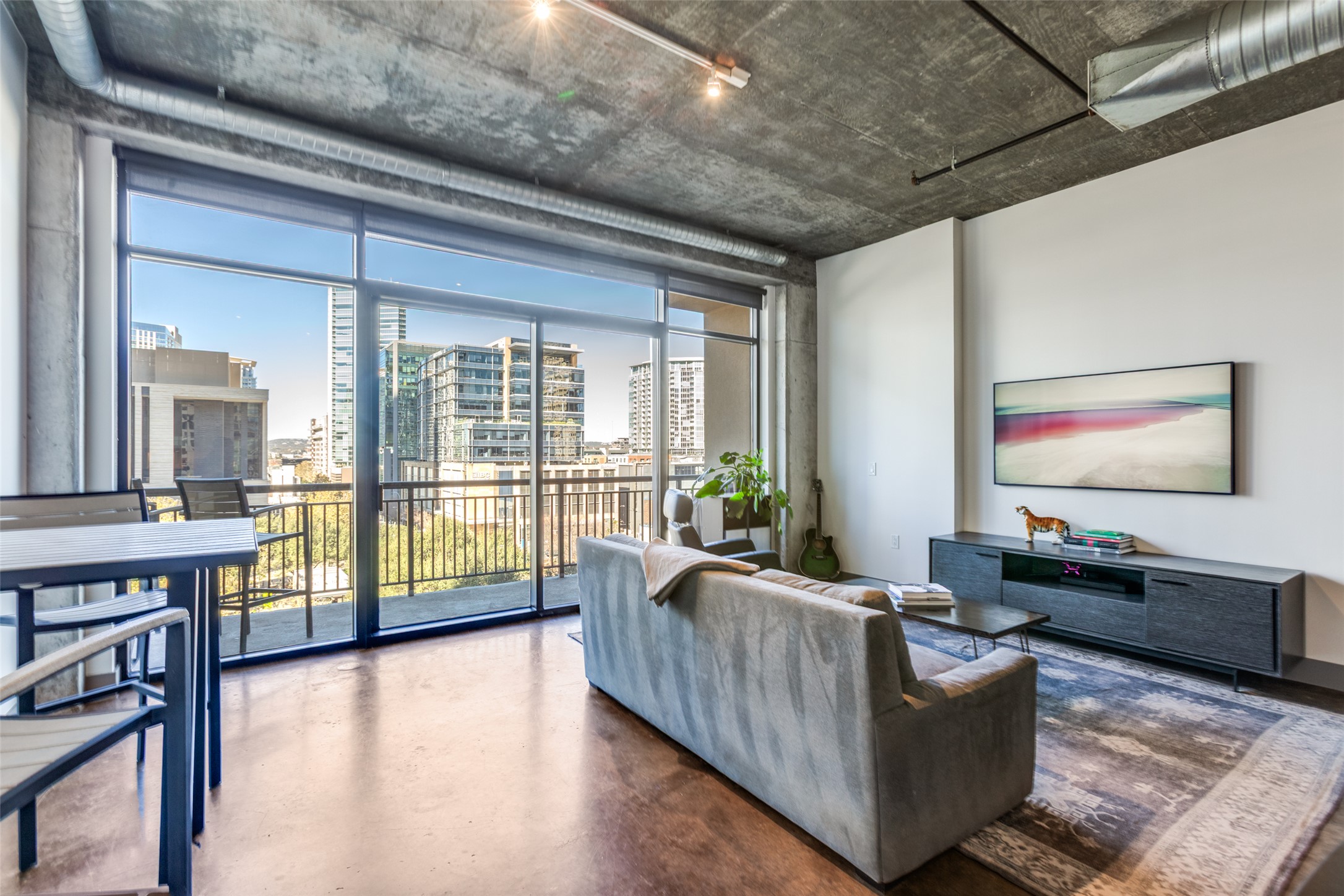 311 West 5th Street, Unit 704 Austin, TX 78701 - Photo 1 of 12 a living room with furniture floor to ceiling window and wooden floor