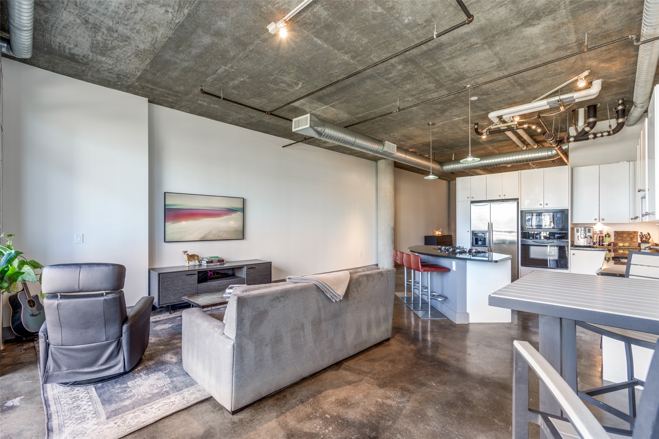 311 West 5th Street, Unit 704 Austin, TX 78701 - Photo 2 of 12 a living room with furniture and a kitchen view