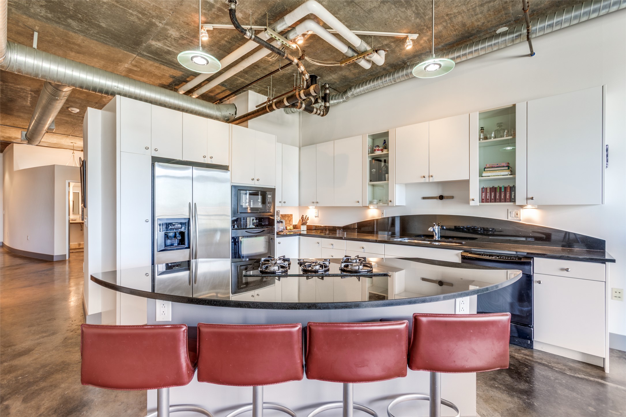 311 West 5th Street, Unit 704 Austin, TX 78701 - Photo 5 of 12 a kitchen with stainless steel appliances granite countertop a sink and a refrigerator