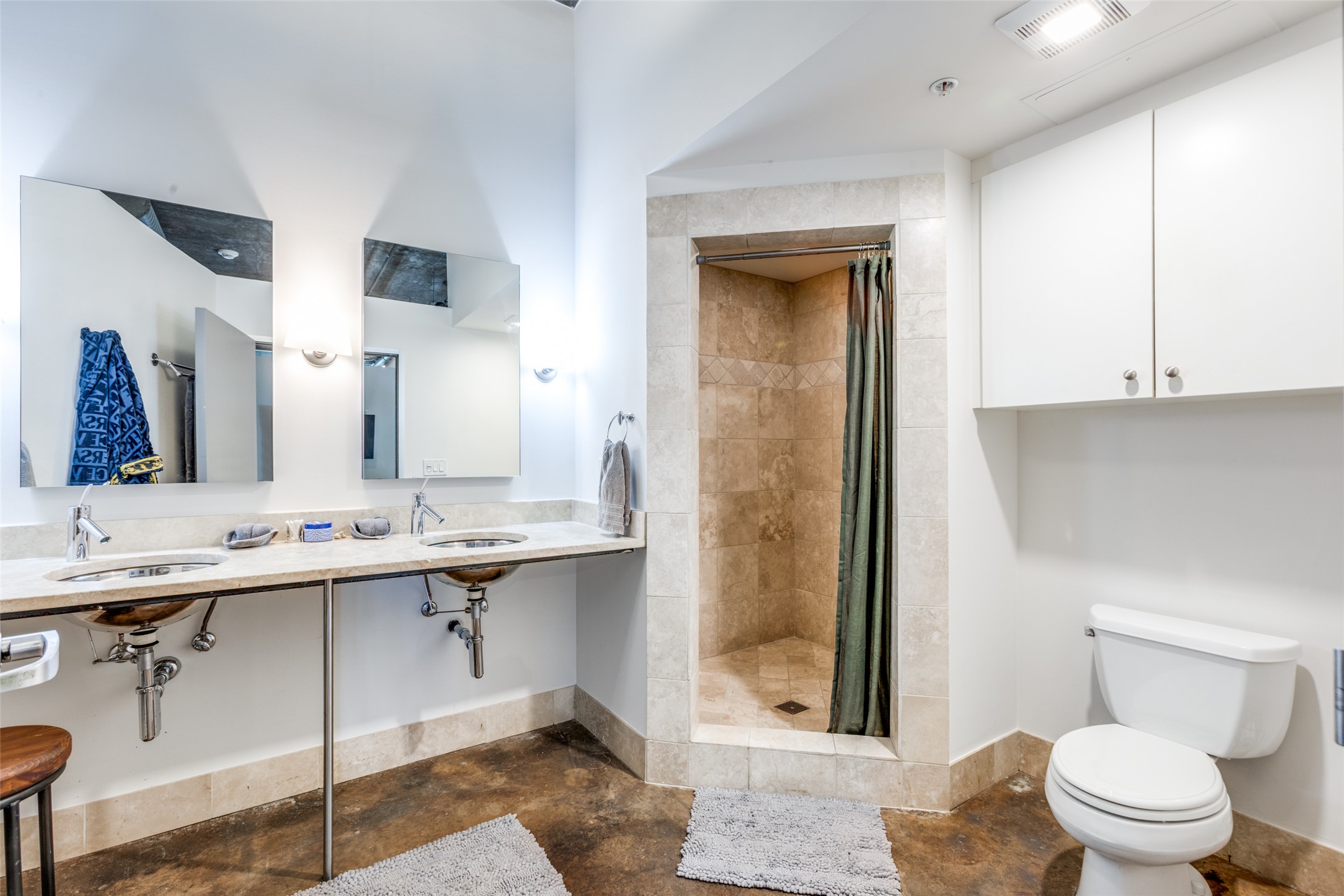 311 West 5th Street, Unit 704 Austin, TX 78701 - Photo 6 of 12 a bathroom with a toilet a sink and mirror