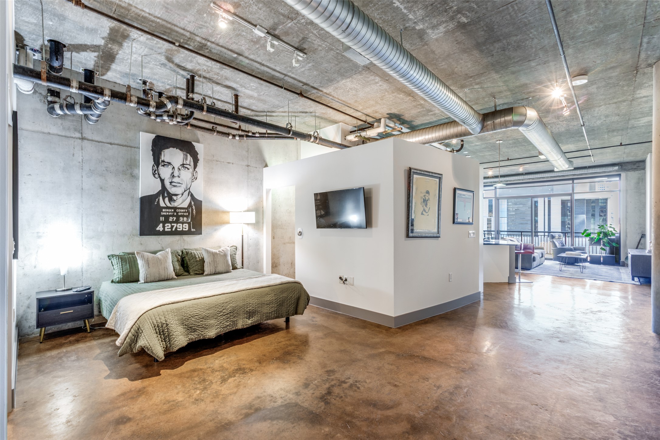 311 West 5th Street, Unit 704 Austin, TX 78701 - Photo 9 of 12 a spacious bedroom with a bed and a chandelier