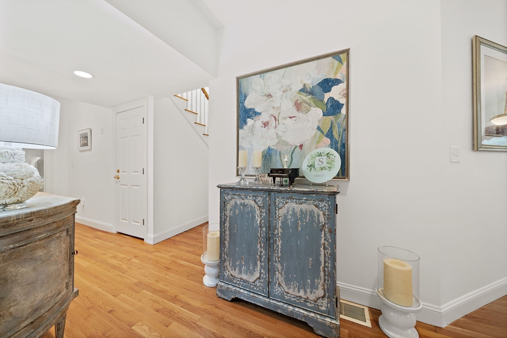 11 Forest Lane, Unit 11 Scituate, MA 02066 - Photo 19 of 42 a view of a hallway with paintings on the wall