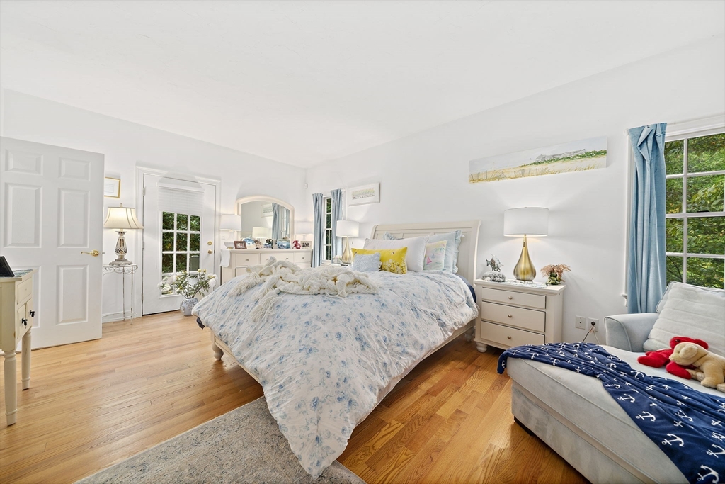 11 Forest Lane, Unit 11 Scituate, MA 02066 - Photo 21 of 42 a spacious bedroom with two beds and large windows