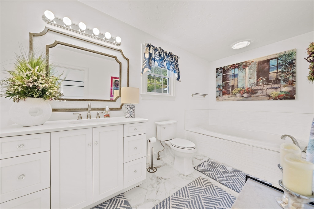 11 Forest Lane, Unit 11 Scituate, MA 02066 - Photo 28 of 42 a bathroom with a sink a toilet and mirror