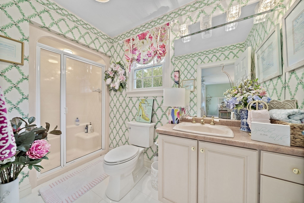 11 Forest Lane, Unit 11 Scituate, MA 02066 - Photo 31 of 42 a bathroom with a sink mirror vanity and toilet
