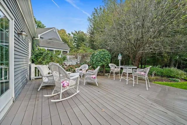 a view of a chairs and table on the wooden deck