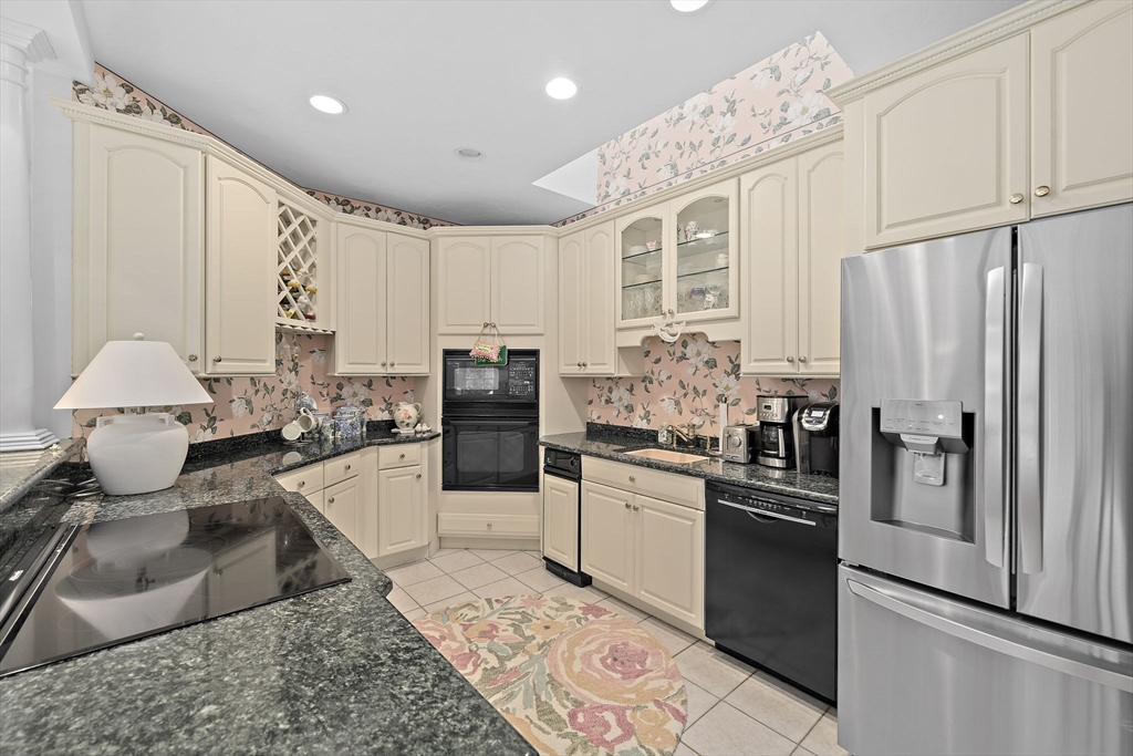 11 Forest Lane, Unit 11 Scituate, MA 02066 - Photo 6 of 42 a kitchen with granite countertop a refrigerator stove and sink