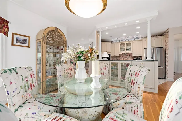 a kitchen with stainless steel appliances kitchen island granite countertop a table and chairs