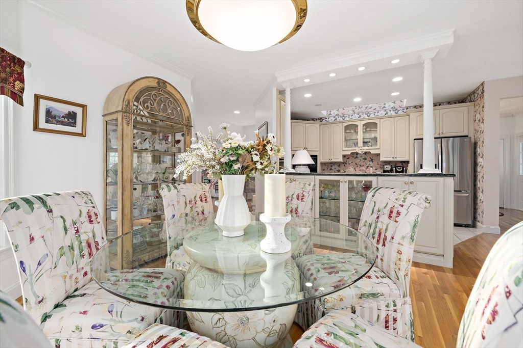 11 Forest Lane, Unit 11 Scituate, MA 02066 - Photo 9 of 42 a kitchen with stainless steel appliances kitchen island granite countertop a table and chairs