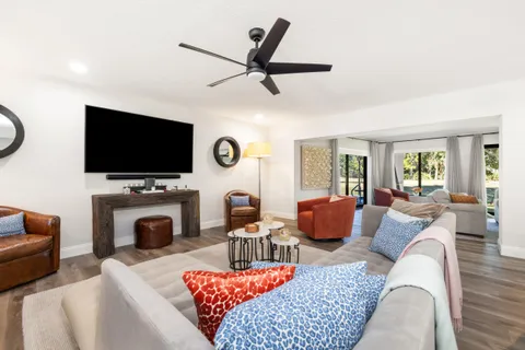 a living room with furniture a fireplace and a flat screen tv