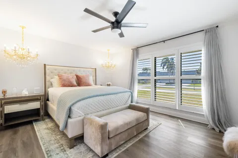 a bedroom with a bed and a large window