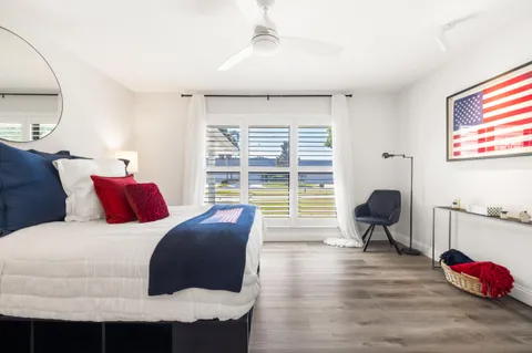 a bedroom with a bed and a large window