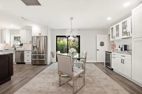 a kitchen with kitchen island a counter top space appliances and cabinets