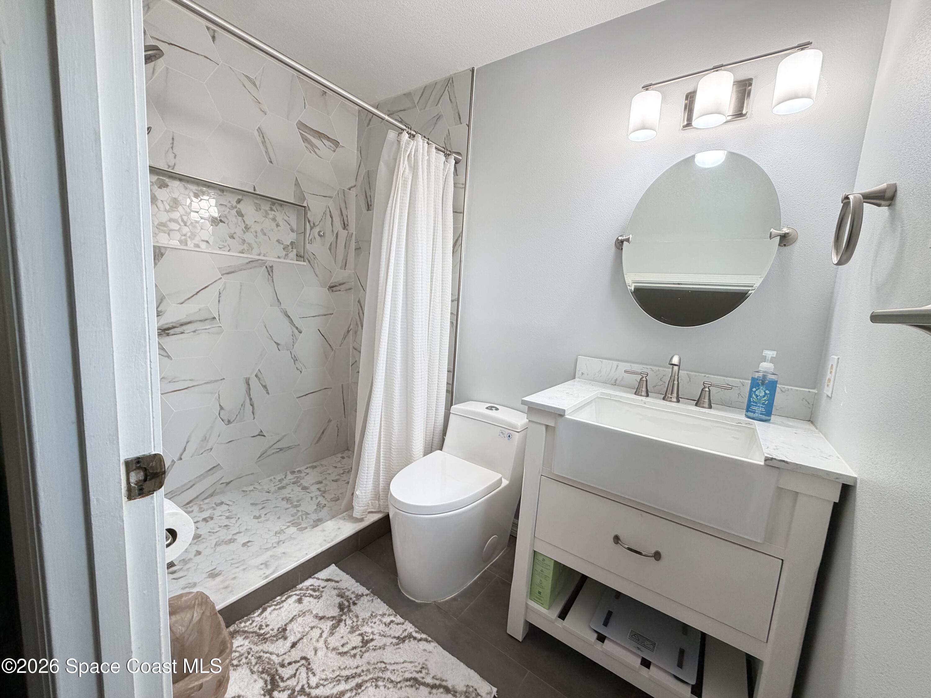 1578 West Powder Horn Road Titusville, FL 32796 - Photo 12 of 22 a bathroom with a sink toilet and shower