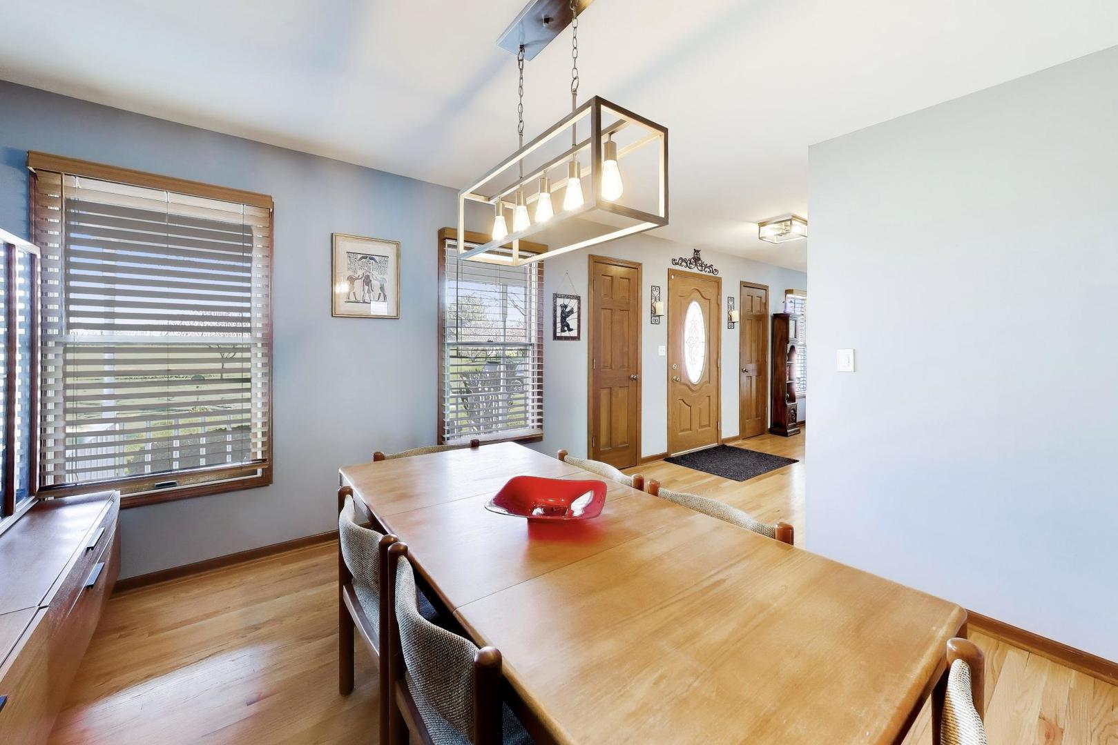 850 Tartans Drive West Dundee, IL 60118 - Photo 12 of 49 a view of a dining room with furniture and a chandelier