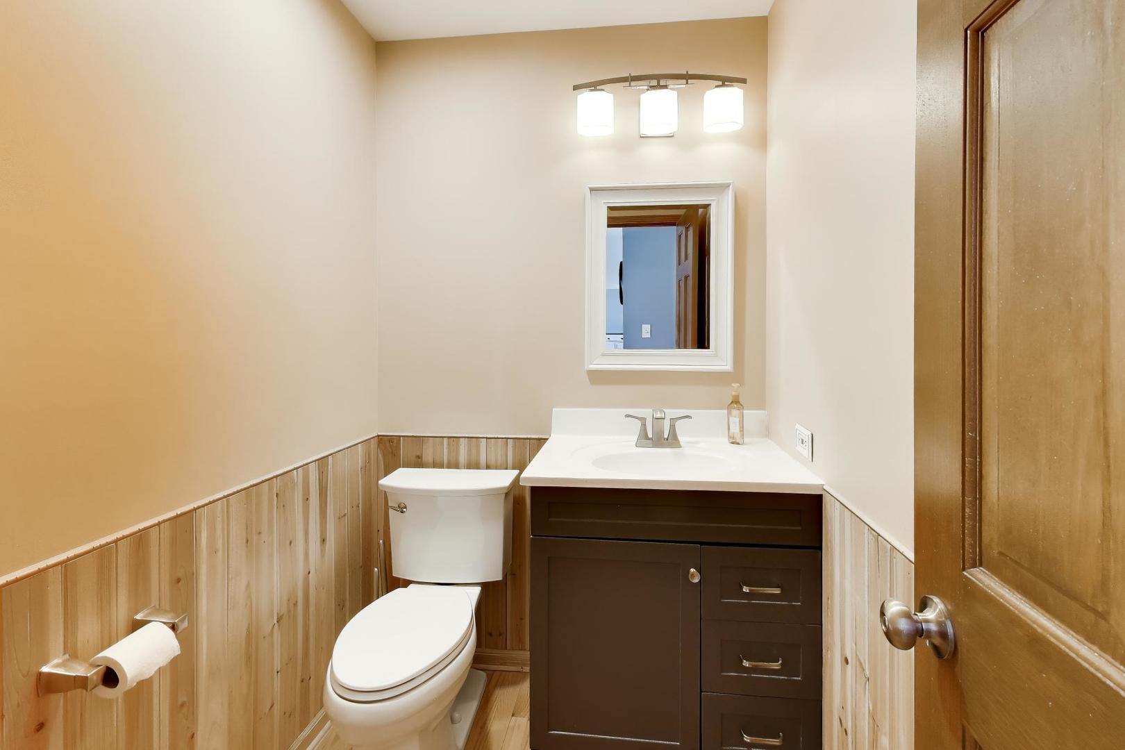 850 Tartans Drive West Dundee, IL 60118 - Photo 20 of 49 a bathroom with a toilet a sink and mirror