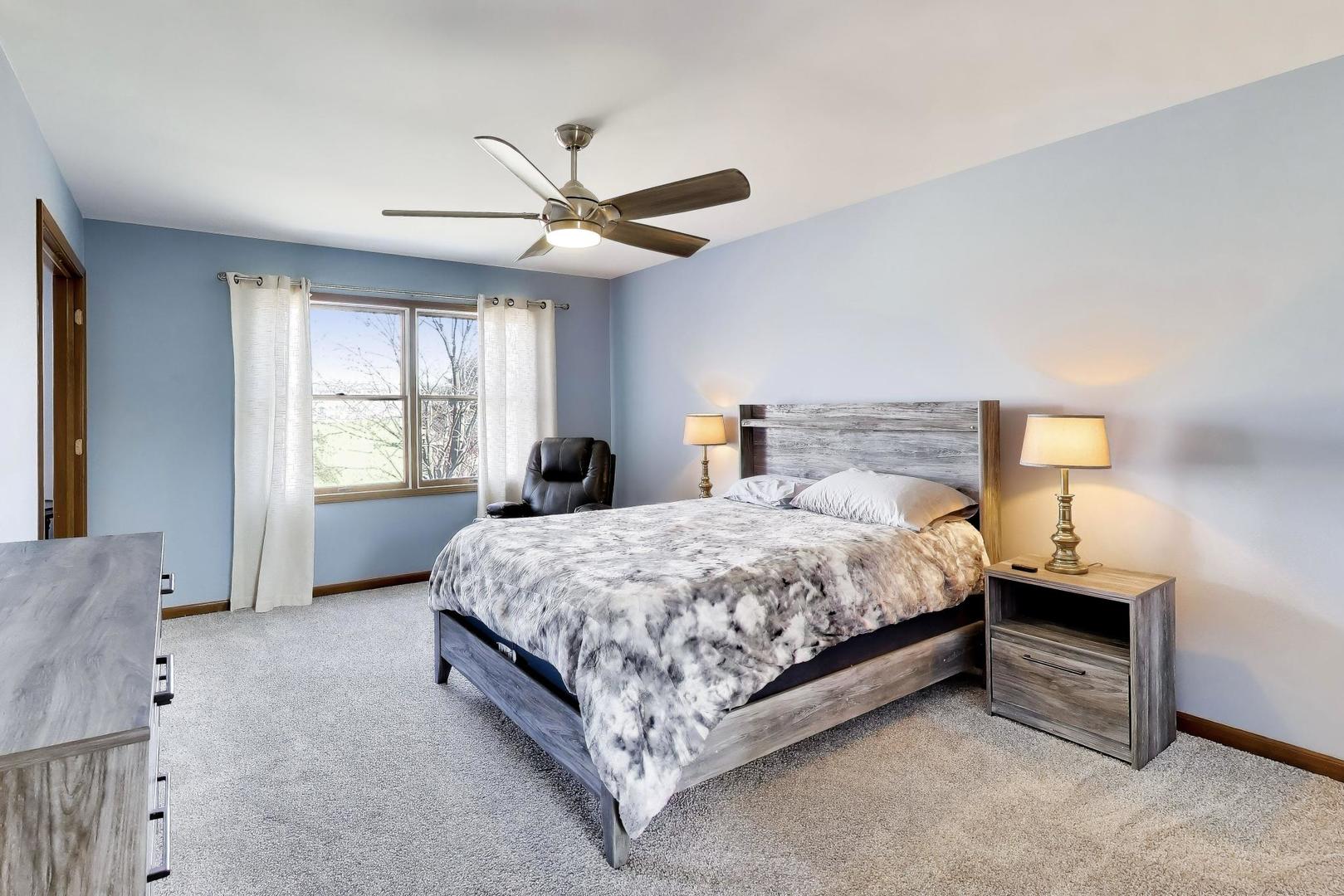 850 Tartans Drive West Dundee, IL 60118 - Photo 23 of 49 a spacious bedroom with a bed and a window