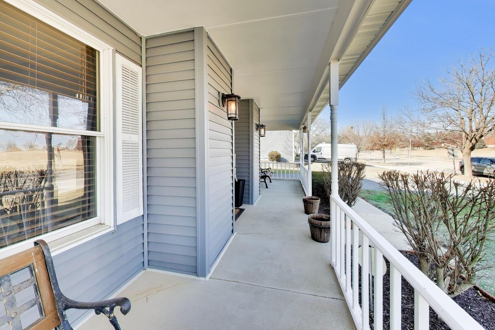 850 Tartans Drive West Dundee, IL 60118 - Photo 4 of 49 a view of a balcony with chairs and wooden fence
