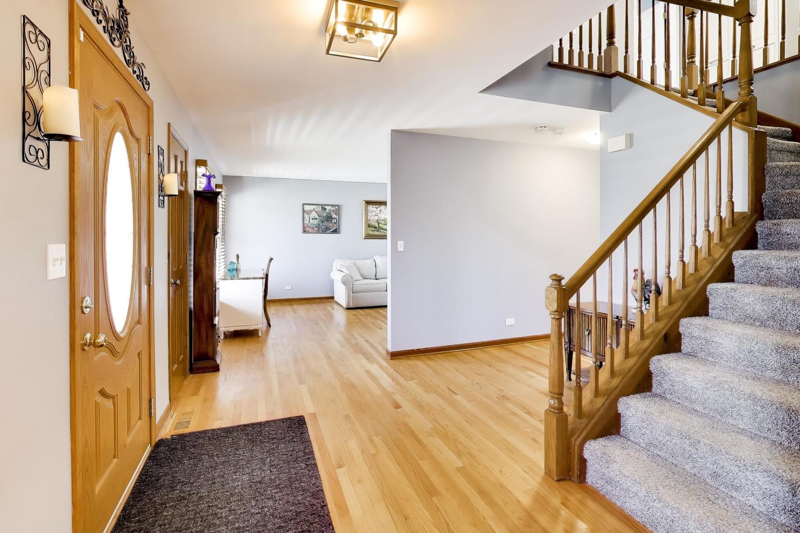 850 Tartans Drive West Dundee, IL 60118 - Photo 7 of 49 a view of entryway and hall with wooden floor