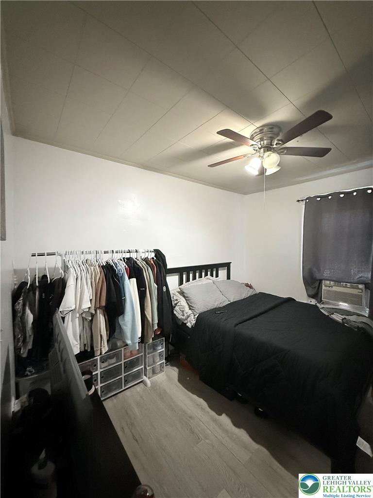 1025 Spring Street Bethlehem, PA 18018 - Photo 12 of 20 Comfortable sleeping quarters feature a cooling ceiling fan and practical flooring.