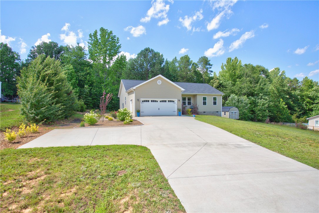 405 Pawnee Drive Walhalla, SC 29691 - Photo 34 of 36 A welcoming driveway leads to this charming residence nestled amongst verdant trees.