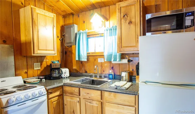a kitchen with a sink a stove and cabinets