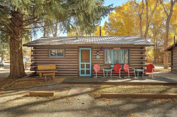 a view of a house with a patio and a yard