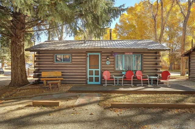 a view of a house with a patio and a yard