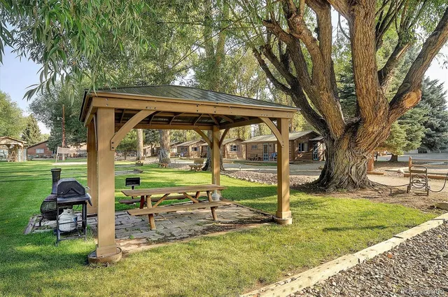 a view of a small house with backyard