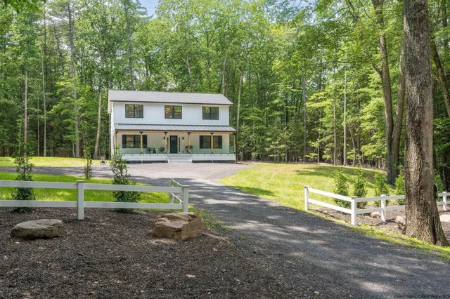 a view of an house with swimming pool and yard