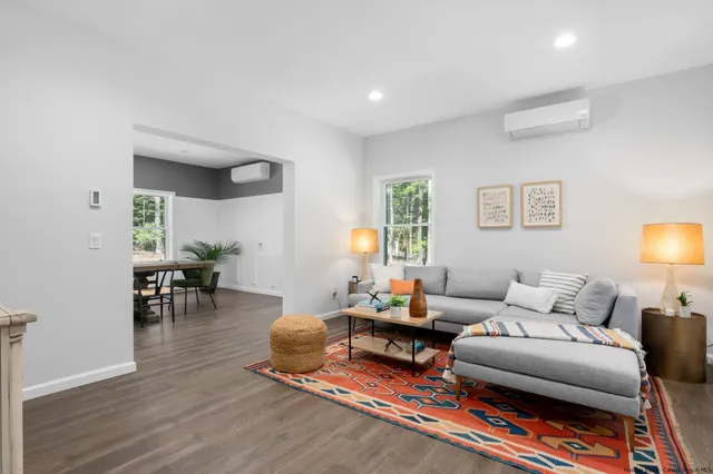 a living room with furniture and a wooden floor