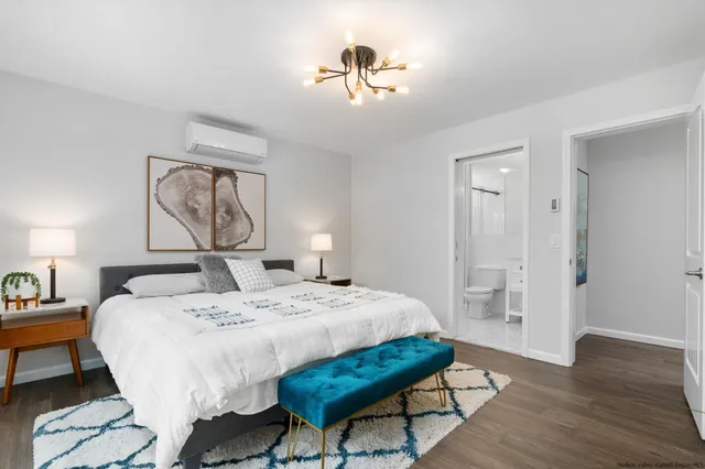 a bedroom with a bed and a chandelier