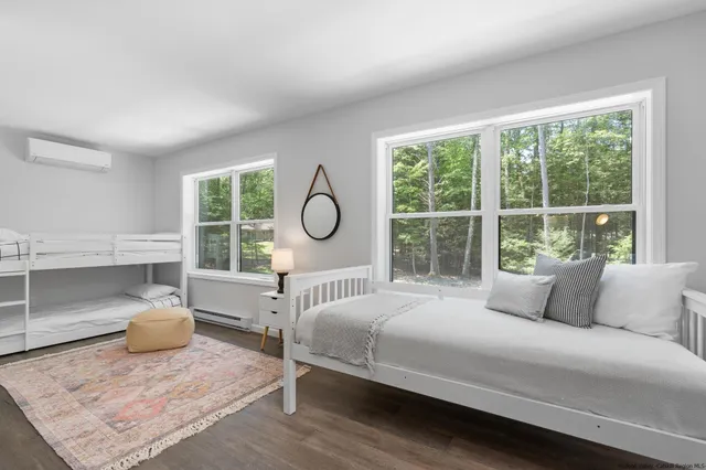 a bedroom with a large bed and a window