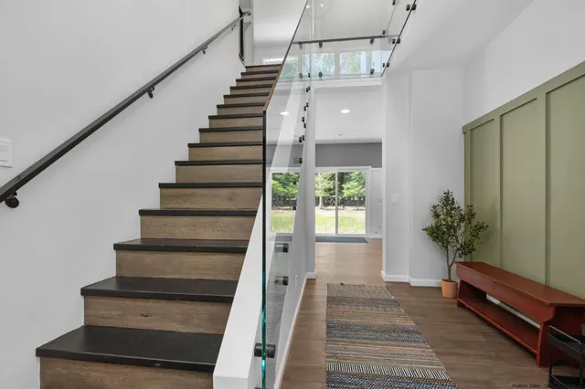 a view of entryway and hall with wooden floor
