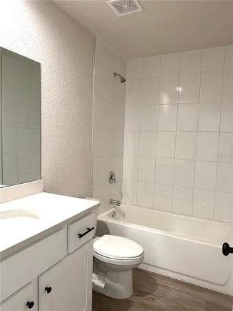 a bathroom with a sink a toilet and a bathtub
