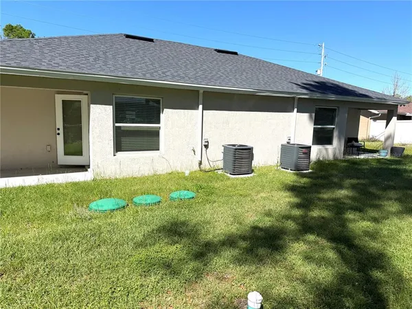 a view of a house with a backyard