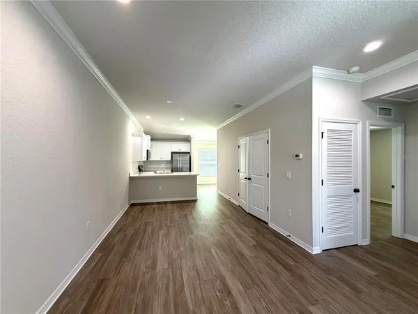 a view of a kitchen with a sink and a refrigerator