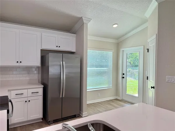 a kitchen with stainless steel appliances a refrigerator sink and cabinets