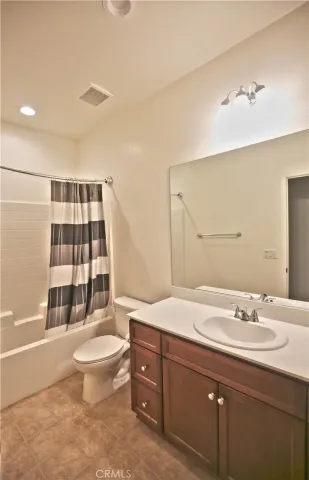 a room with lots of furniture and a potted plant