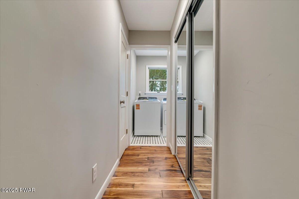 107 Kiel Road Milford, PA 18337 - Photo 40 of 71 a view of a hallway with wooden floor and a bathroom