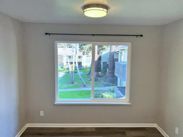 a view of a hallway with a livingroom and a bathroom