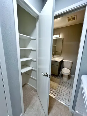 a view of a house with a wooden fence