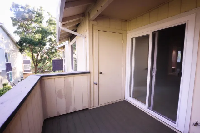 a view of front of a house with potted plants