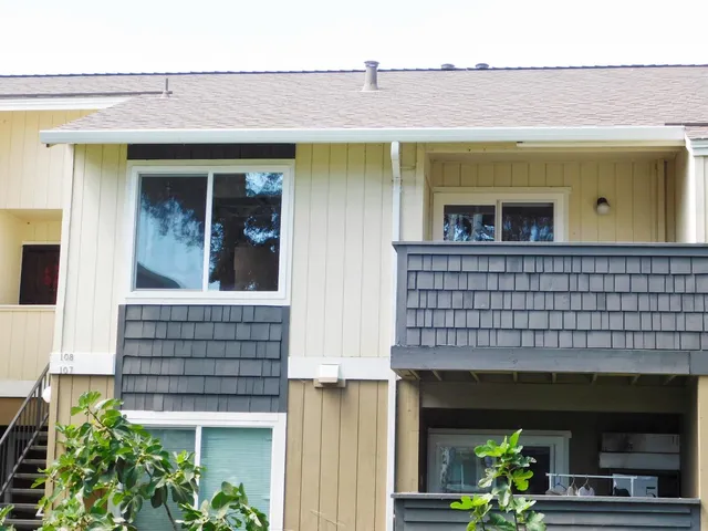 a front view of a house with a garden and plants