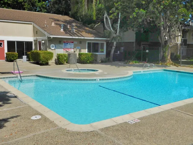 a front view of a house with a garden and garage