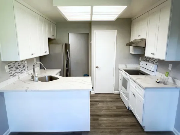 a kitchen with a sink stove and refrigerator