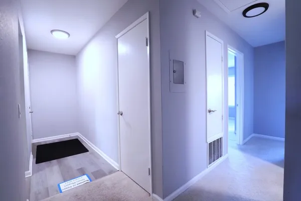 a view of a hallway with wooden floor