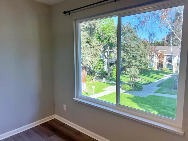 an empty room with windows and closet