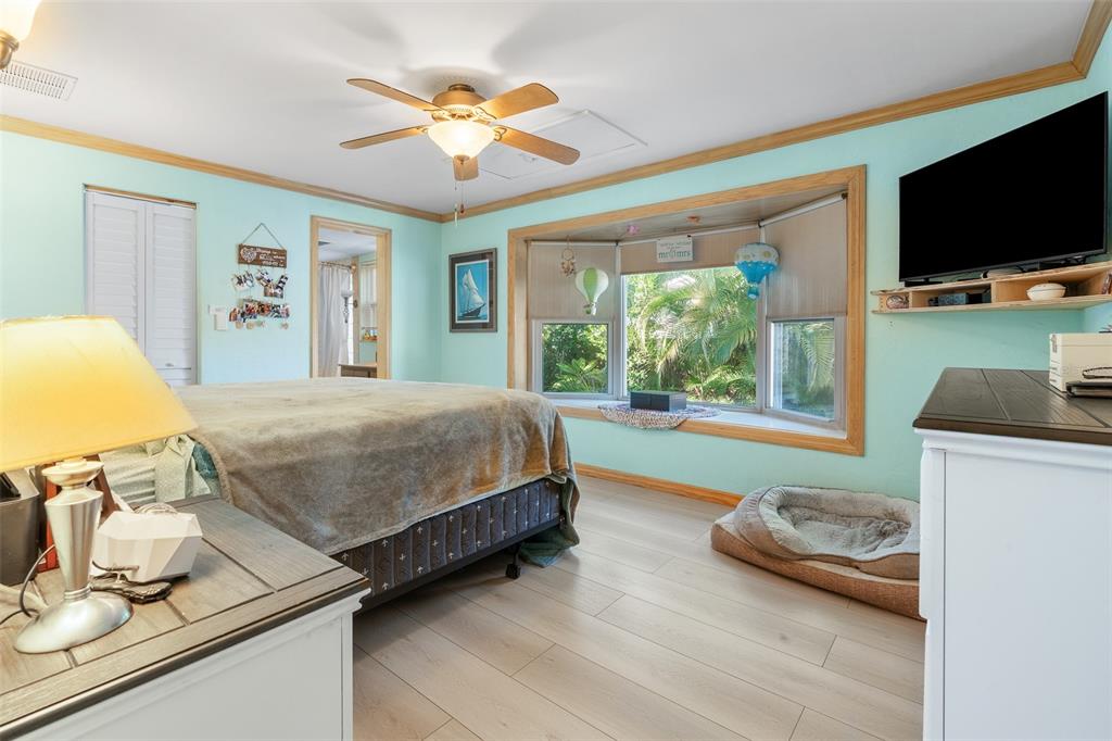 603 Ruskin Road Clearwater, FL 33765 - Photo 16 of 41 a bedroom with furniture and a flat screen tv