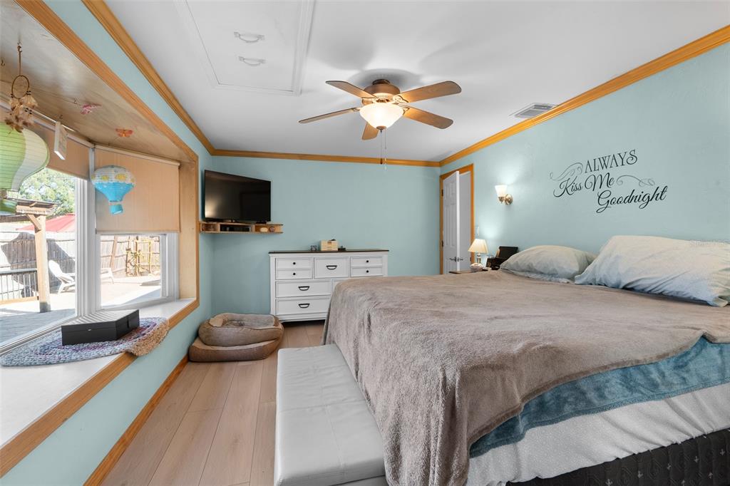 603 Ruskin Road Clearwater, FL 33765 - Photo 17 of 41 a spacious bedroom with a bed and a chandelier